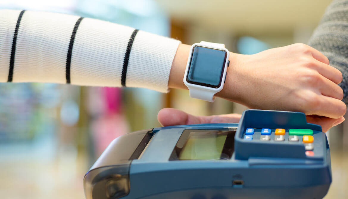 woman paying using her Apple Watch to pay