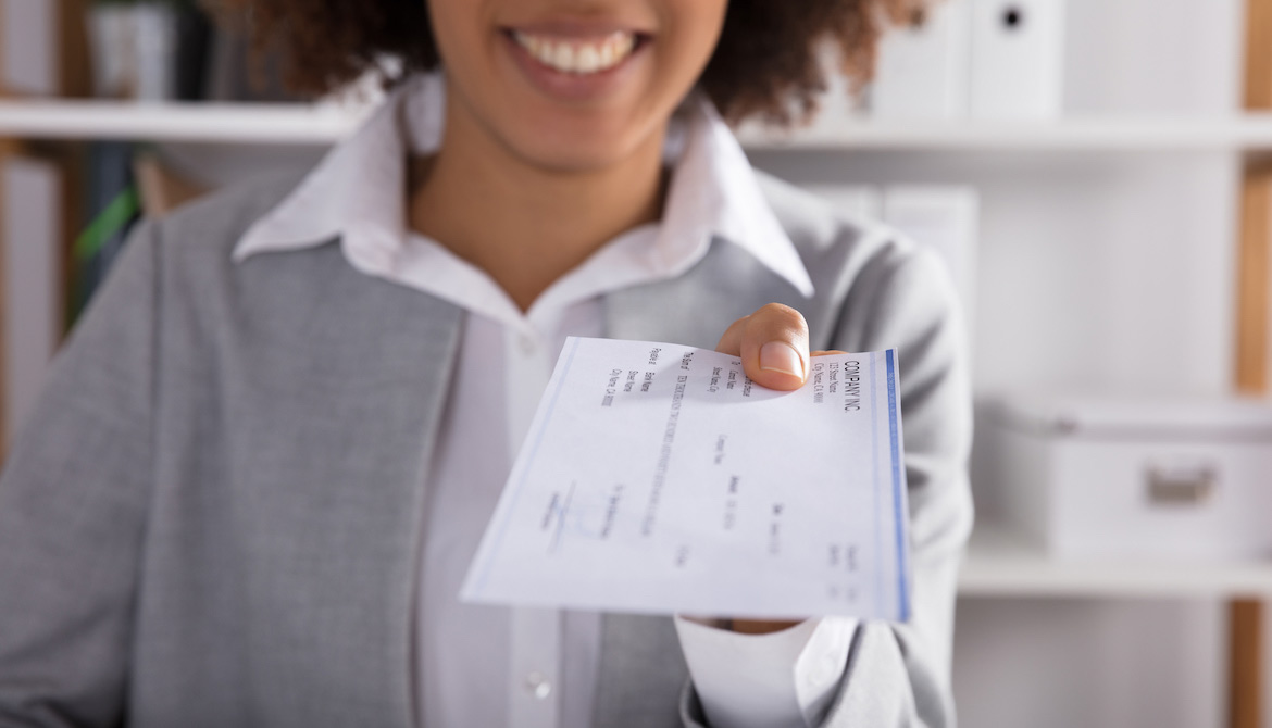 female executive receiving her paycheck as compensation for her work