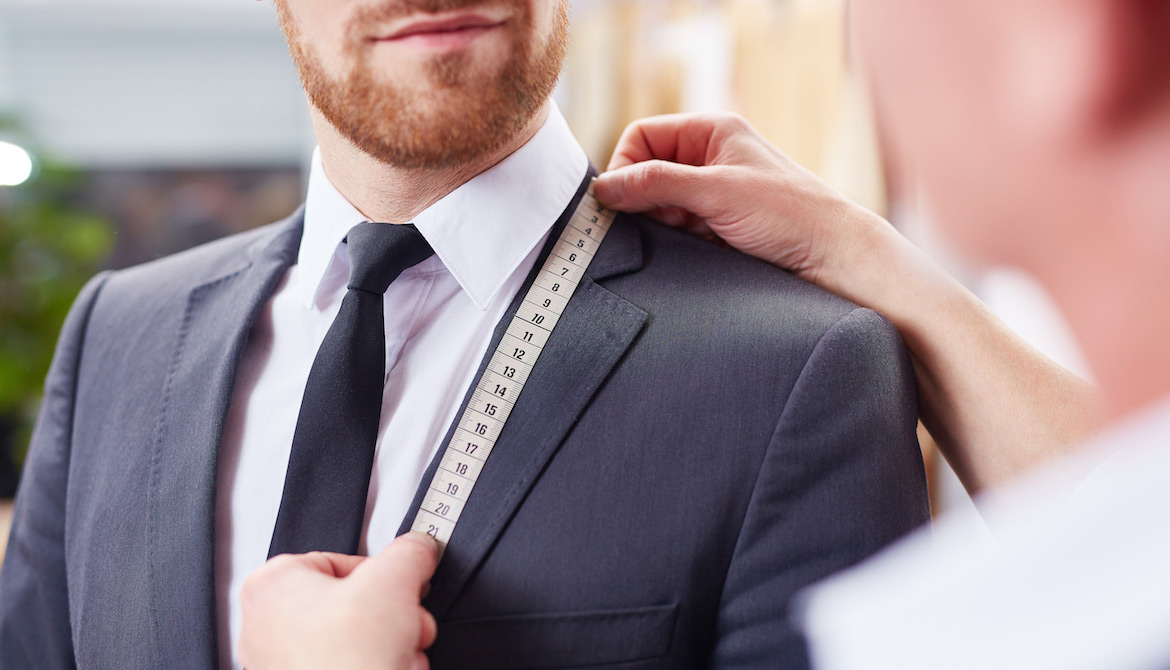 executive getting custom-fitted for a suit