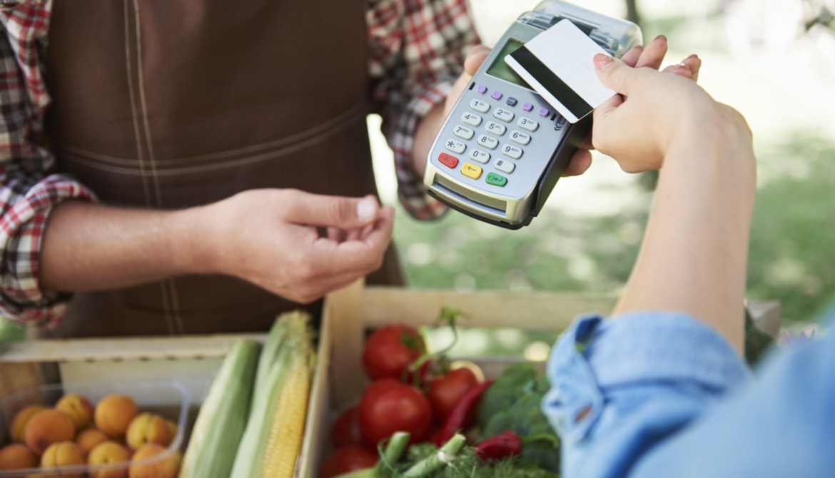 customer using a contactless card to buy produce