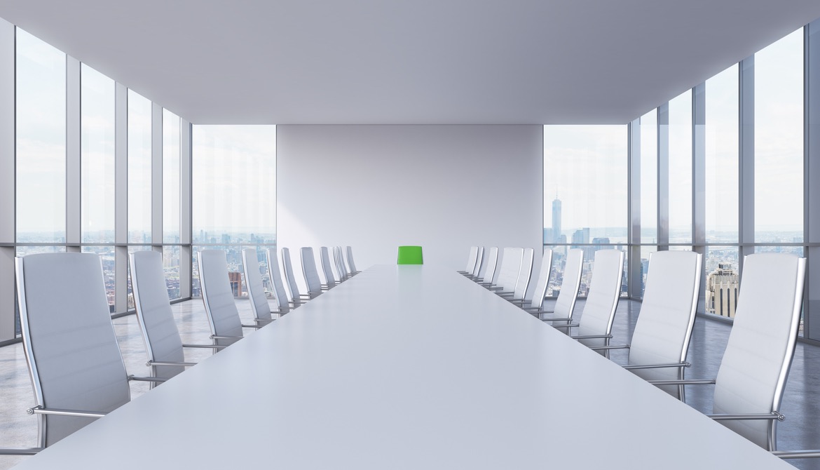 White modern conference room with a green chair in a head of the table