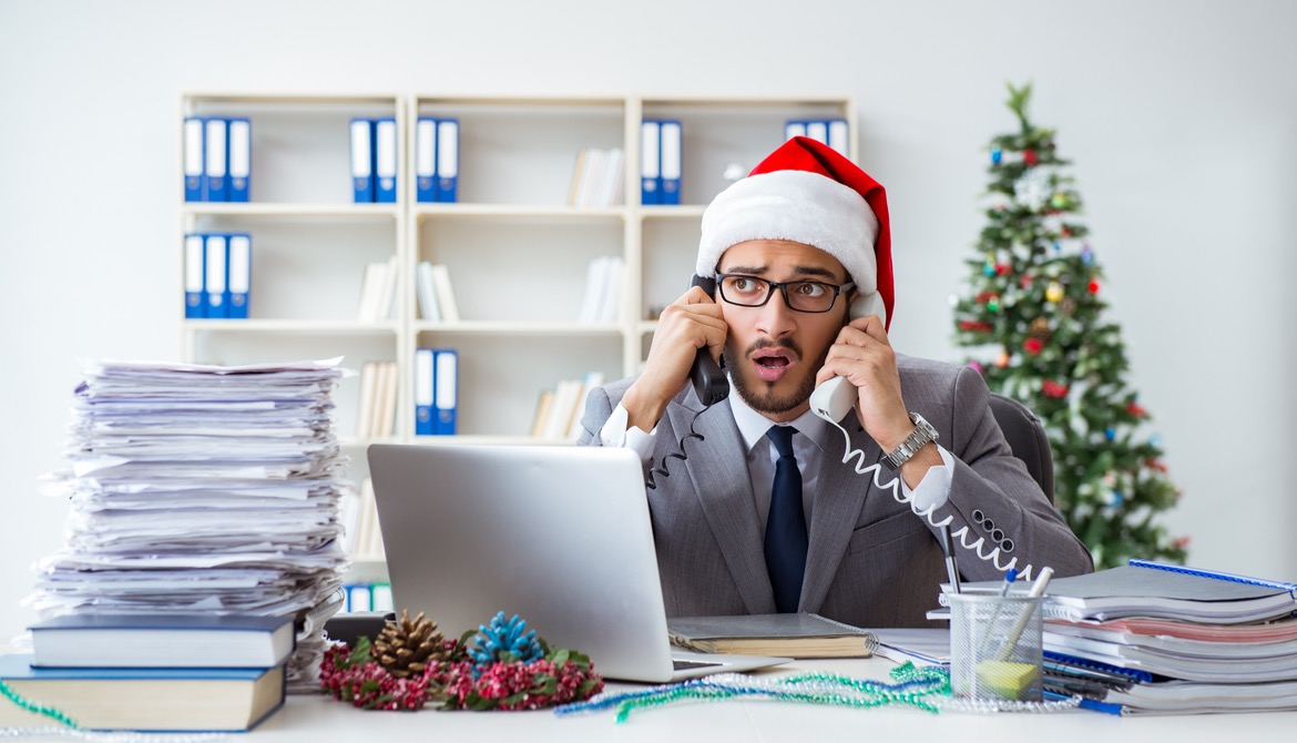 Stressed businessman celebrating Christmas in the office