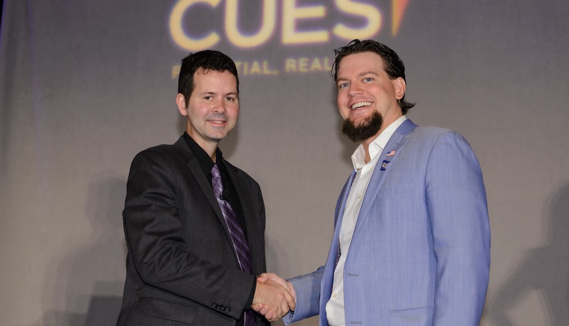 2017 CUES NTCUE winner Geoff Bullock shakes hands with Tim McAlpine of Currency Marketing