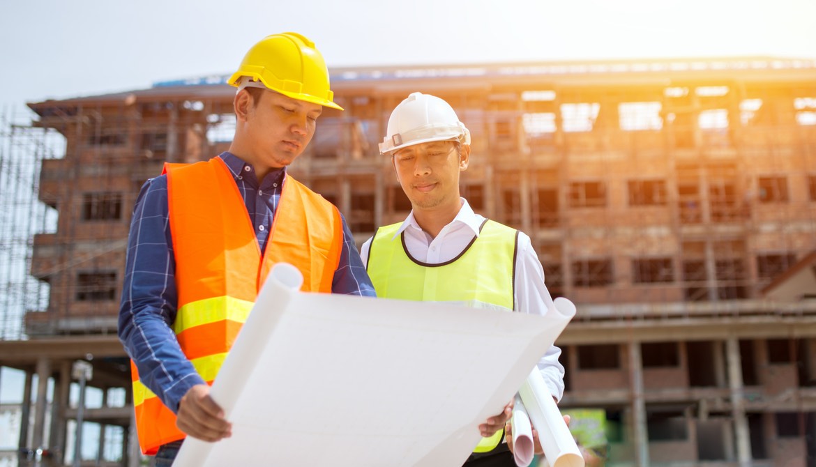 Architect and contractor reviewing plans during a construction project