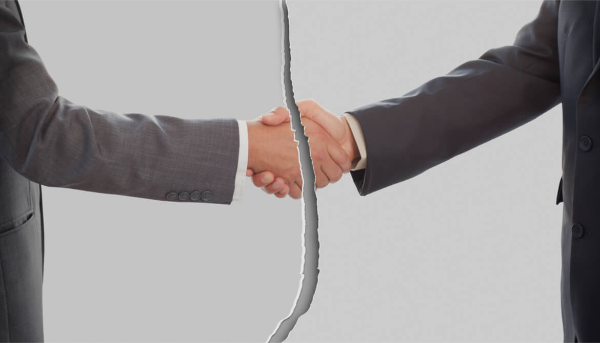 broken or torn image of businessmen shaking hands