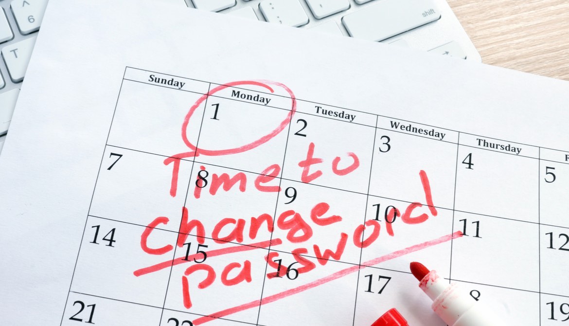 calendar with note to change password laying on a keyboard