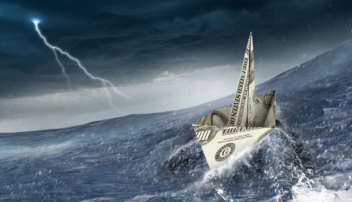 dollar bill origami boat sails into a storm on rough waters