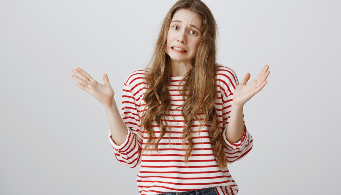young woman in red and white striped shirt looking guilty