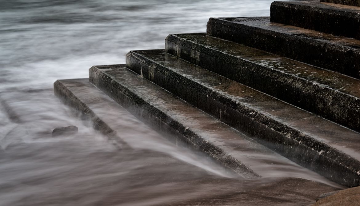 tide rising to cover stone stairs