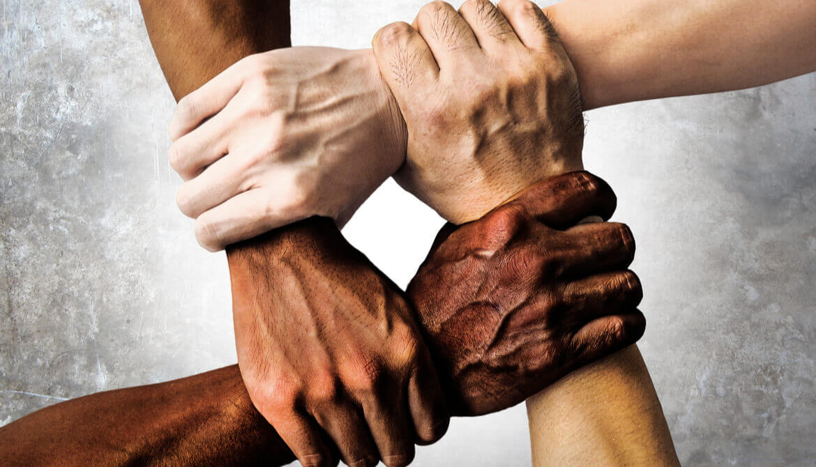 African American, Asian, and Caucasian fists in a circle