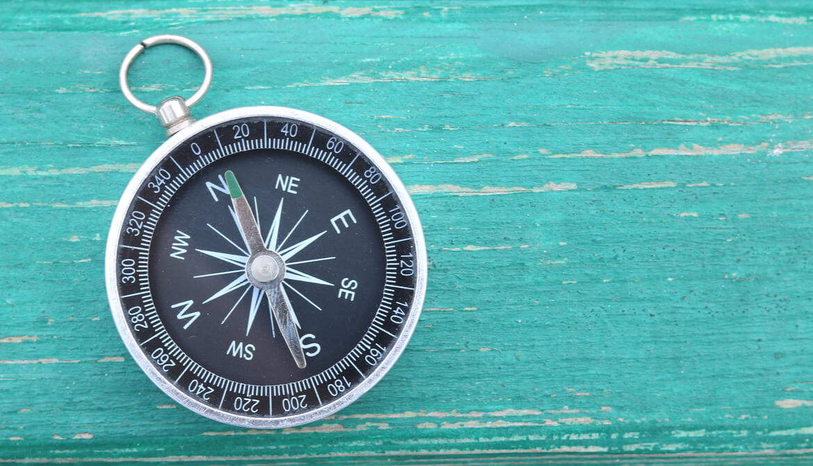 classic round compass on blue background