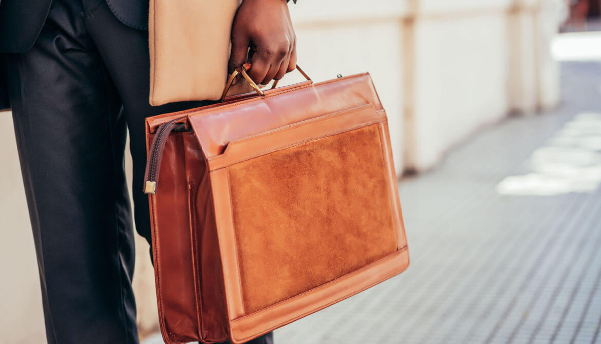 businessman walks with briefcase