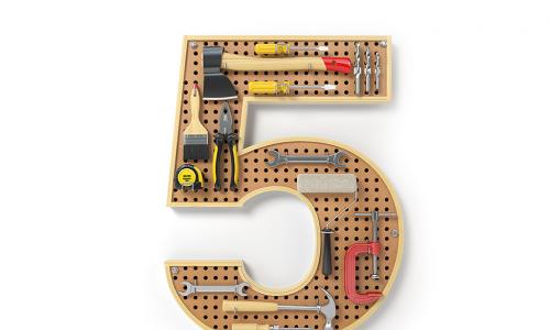A pegboard in the shape of a number 5 with tools on it