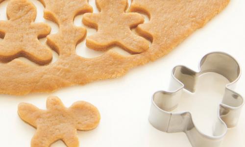 a cookie cutter with gingerbread men cookie shapes