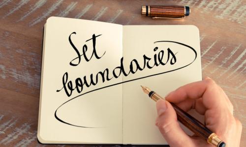 hand writing Set boundaries in a notebook with a fountain pen