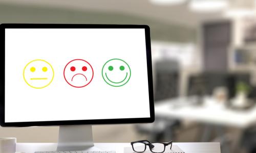 computer displaying yellow neutral green happy and red sad smiley faces