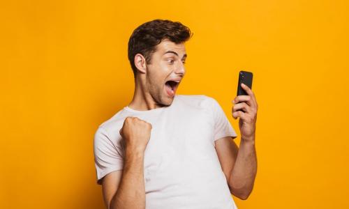 ecstatic young man with cell phone