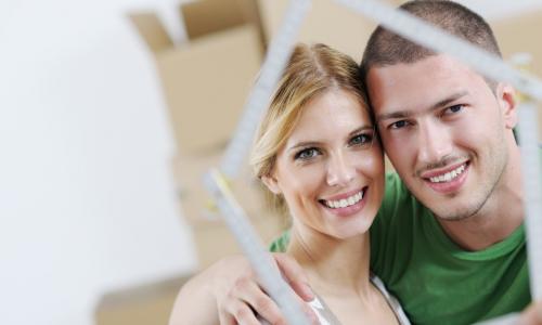 couple look through frame in shape of house