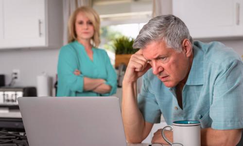 senior couple kitchen laptop financial concerns