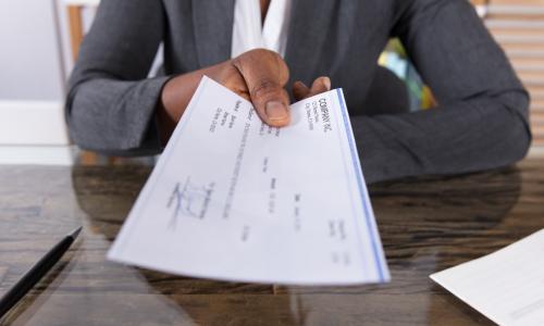 loan check being handed over by a business executive