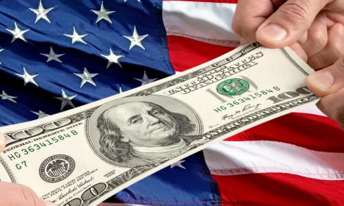 tug of war with 100 dollar bill and a US flag background