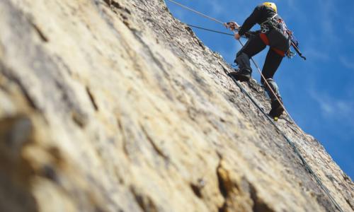 climber climbs a rock wall