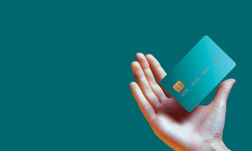 hand holding out floating teal credit card