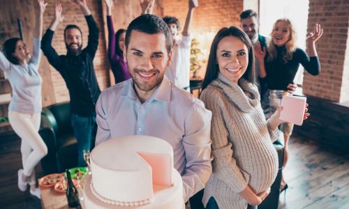 man with cake, pregnant woman with present, co-workers, office baby shower