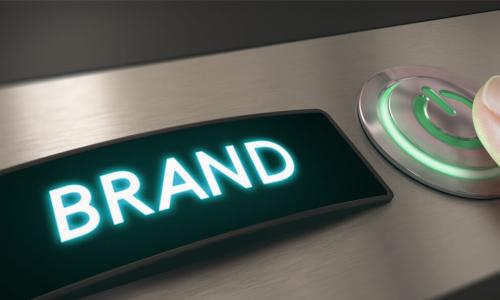 finger reaching out to press power activation button next to glowing brand sign