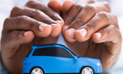 hands protecting blue car