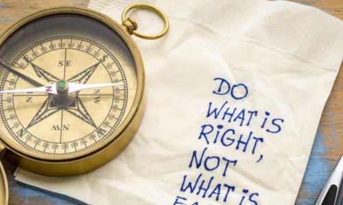compass with napkin and writing saying do the right thing