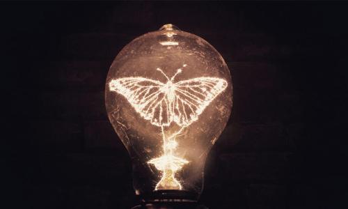 glowing lightbulb with a butterfly shaped filament