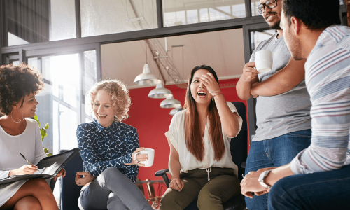 co-workers sitting in a circle laughing