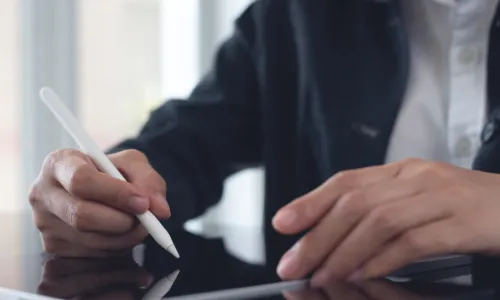 man signing with iPen on tablet