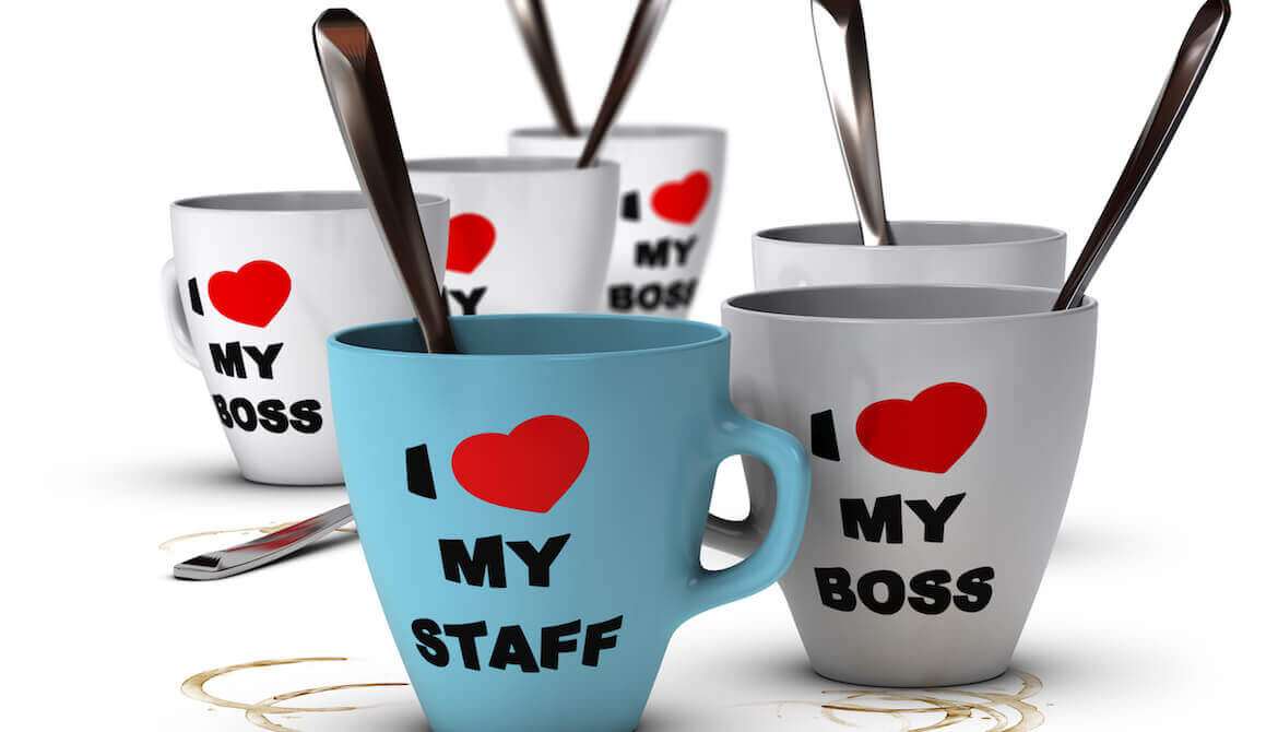 Collection of white and blue mugs that say “I heart (sic) my staff” and “I heart (sic) my boss”
