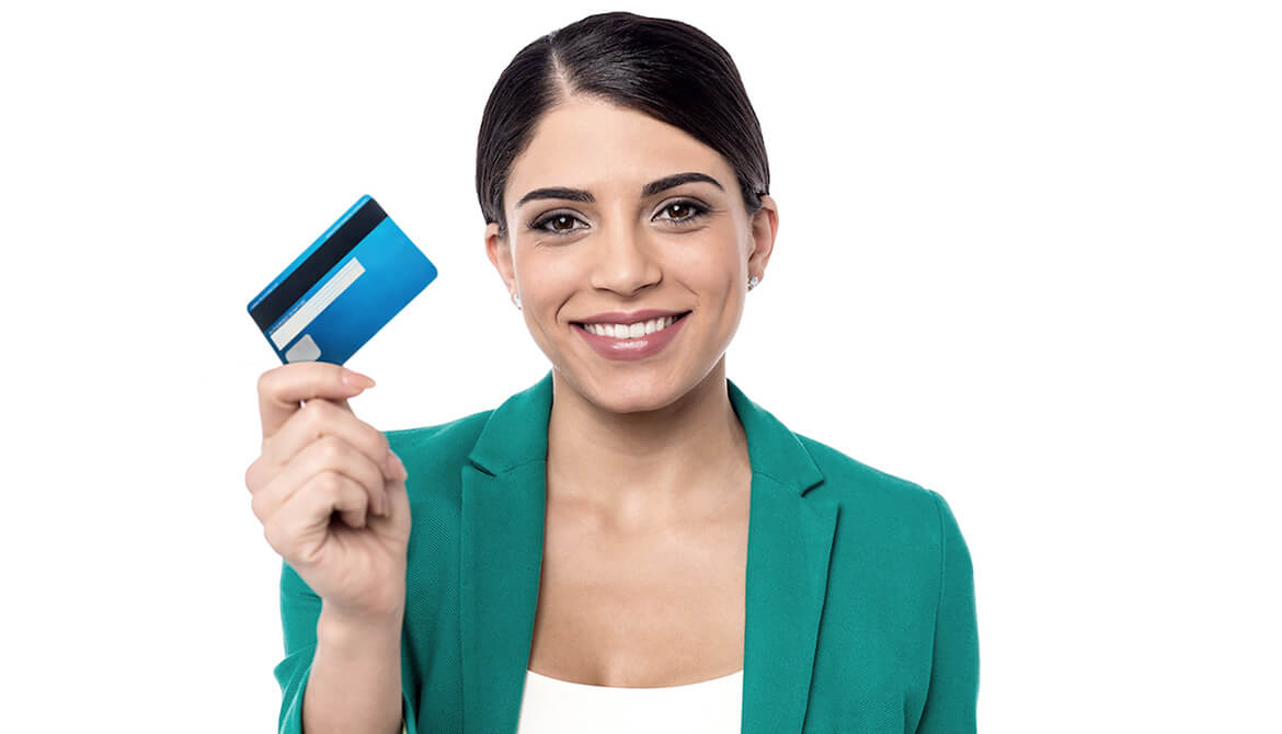 Female credit union staff holding up a new credit card