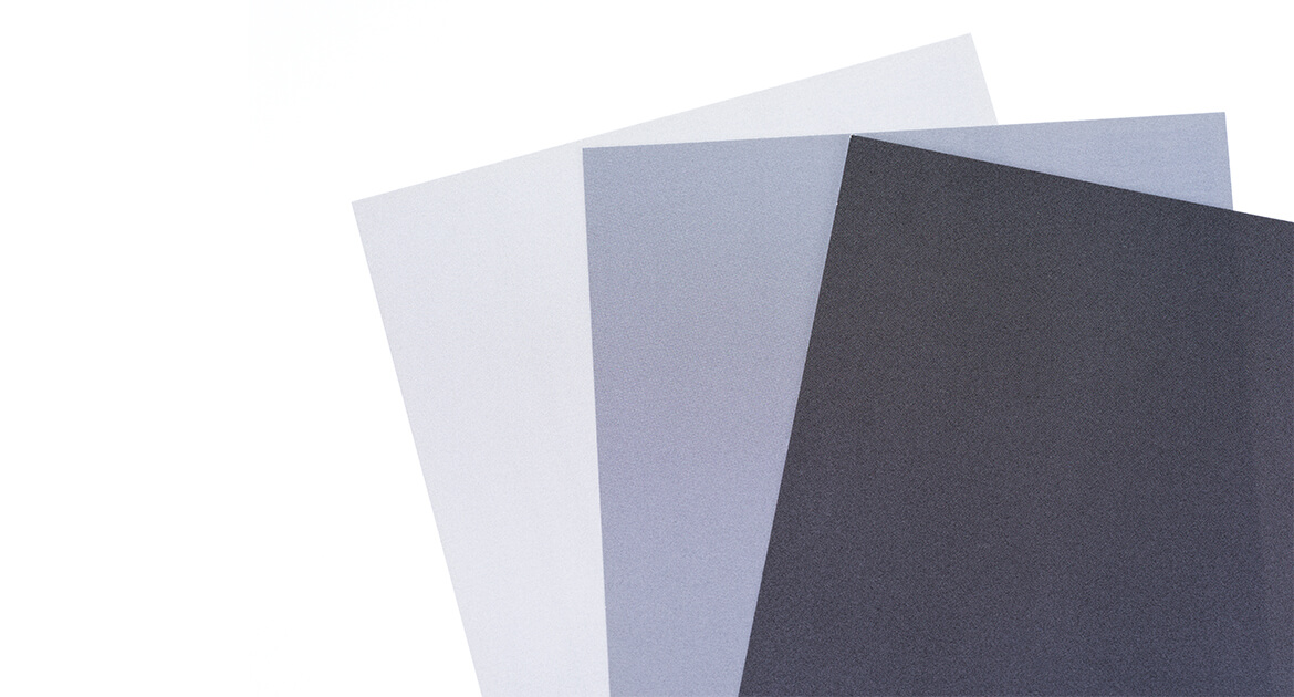 three papers each a different shade of gray