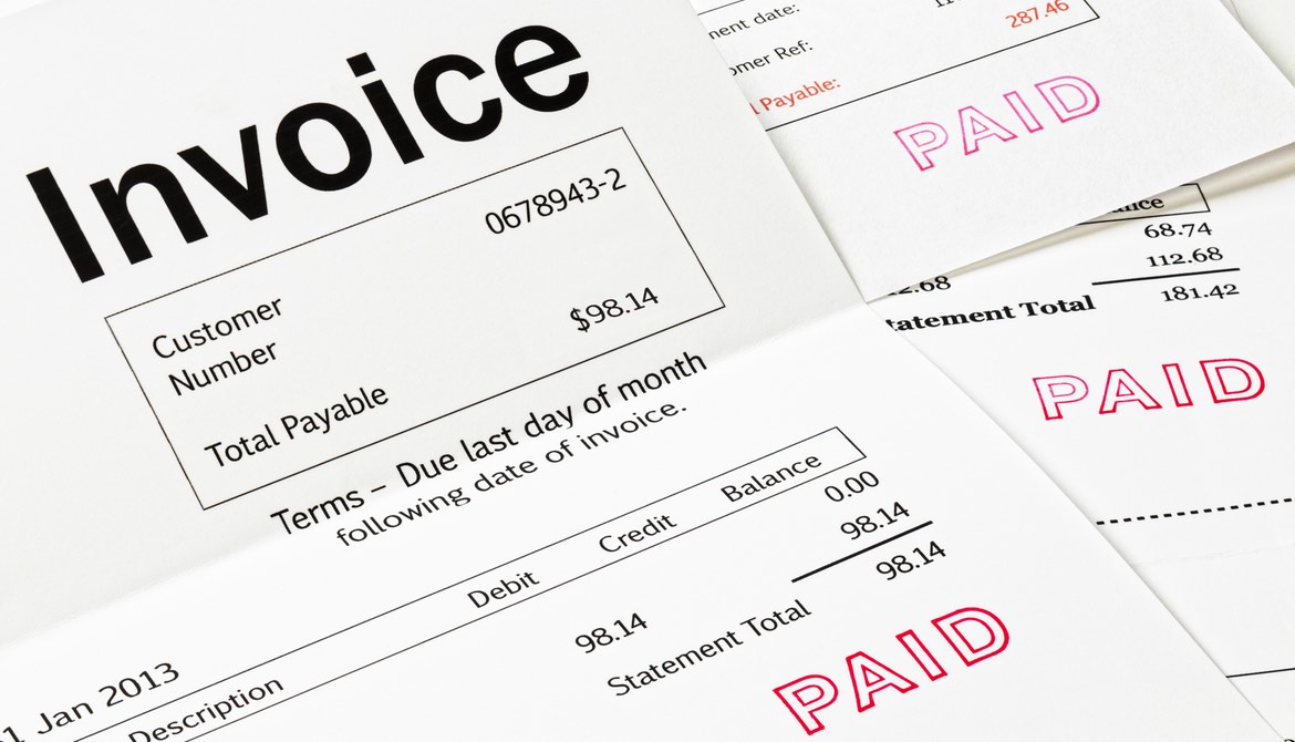 Invoices with PAID stamped on them in red ink