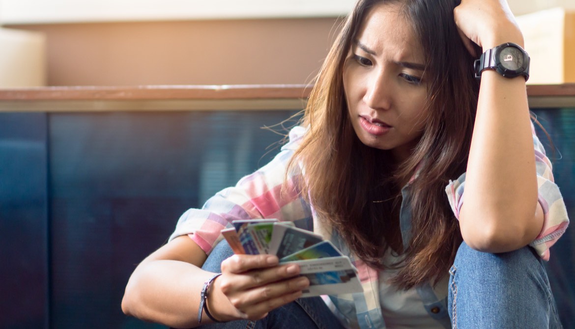 stressed young woman trying to pay credit card debt