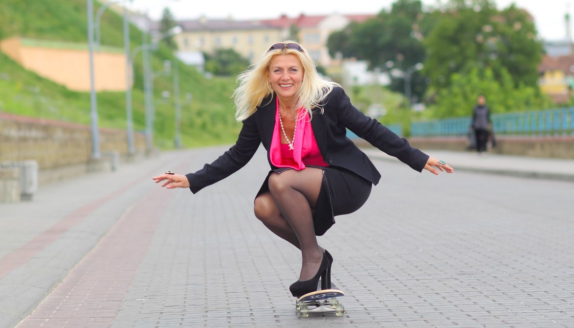 female executive on skateboard