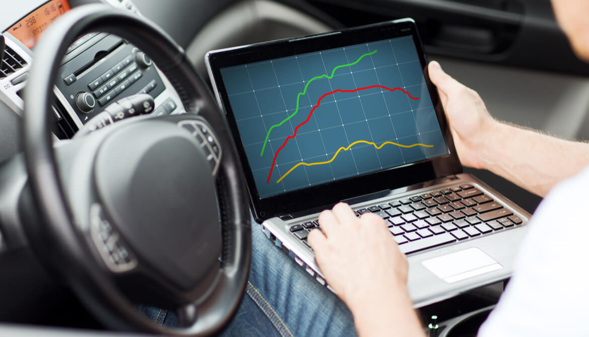 close up of man using laptop computer in car