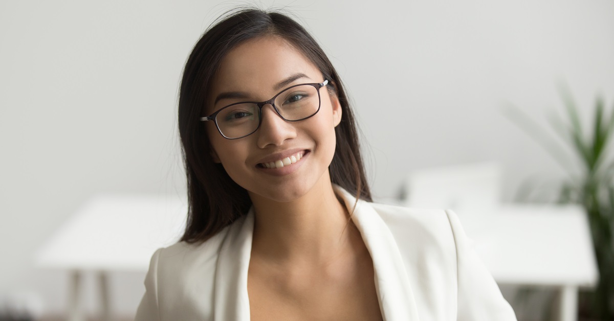 smiling engaged young female employee of Asian descent