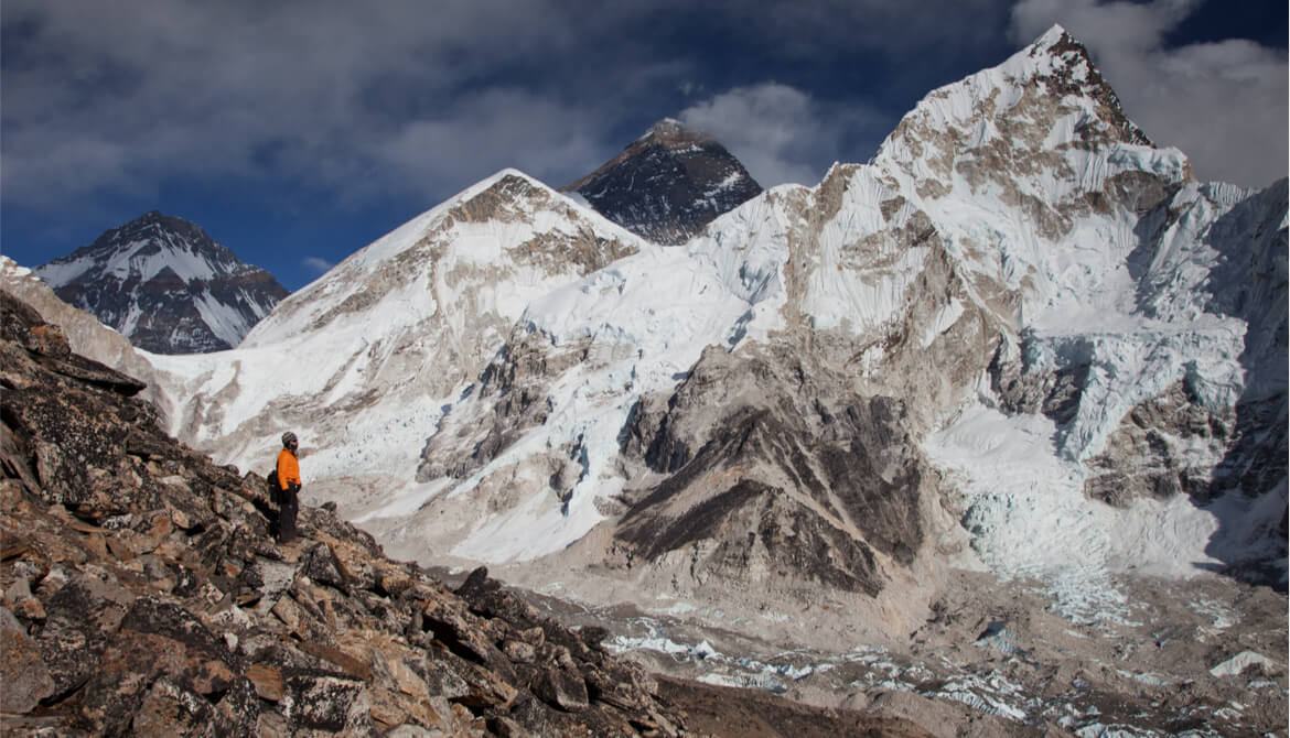 man looking up at Mt. Everest 