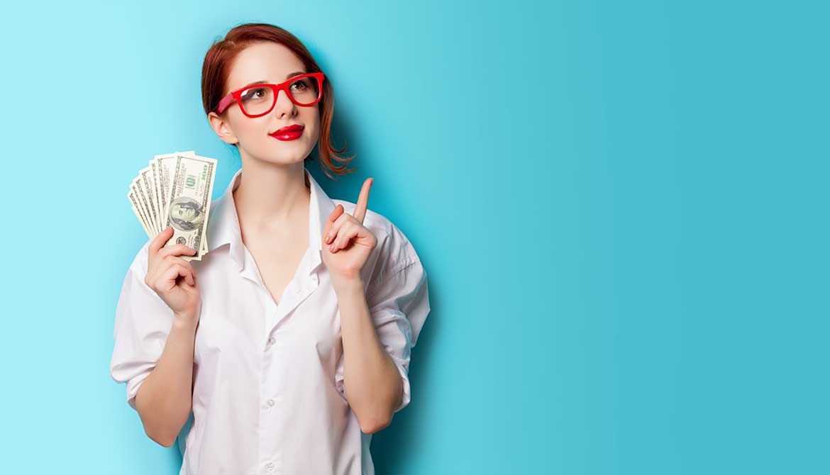 thoughtful young woman wearing glasses and holding several 100 dollar bills