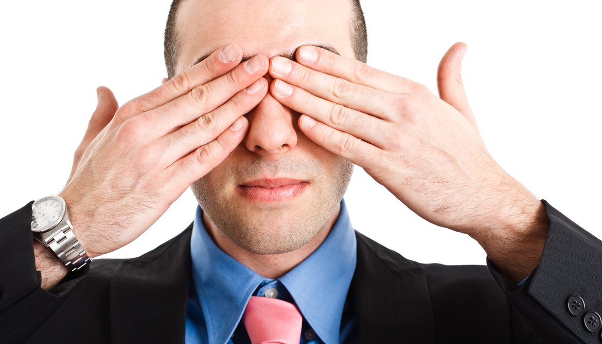 executive covering his eyes with his fingers