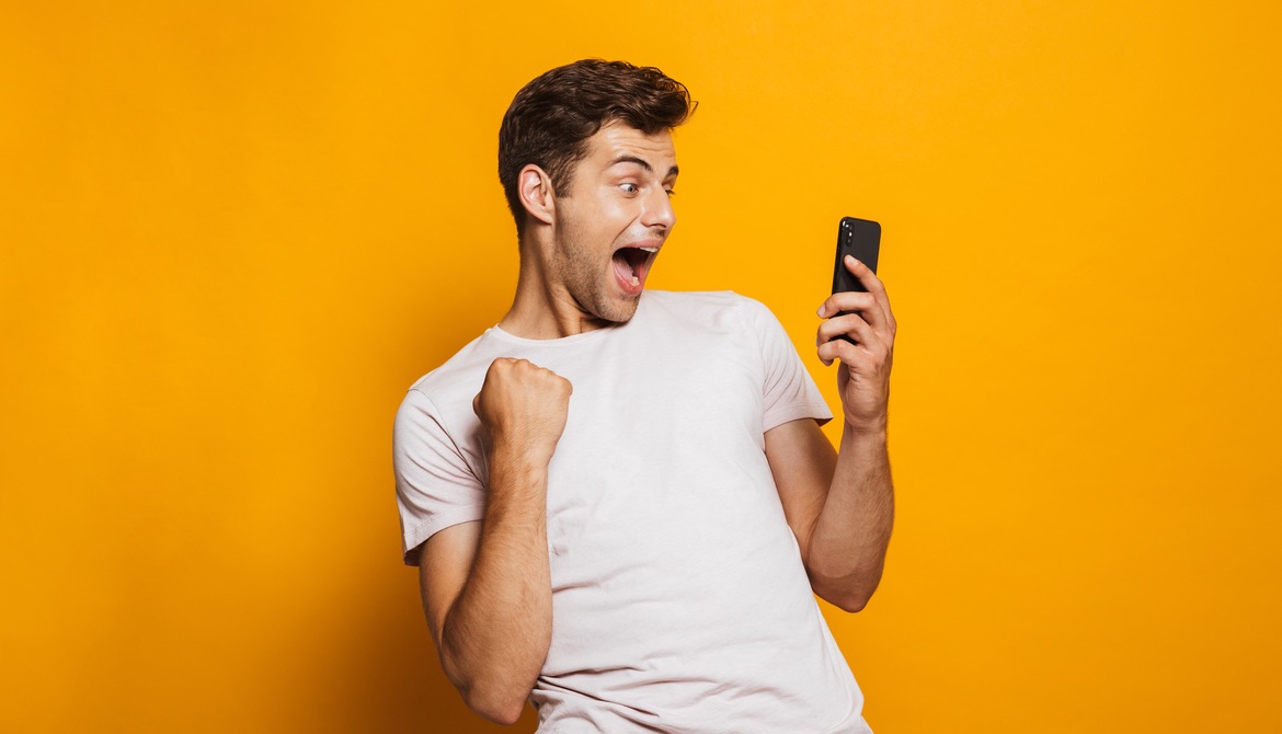 ecstatic young man with cell phone