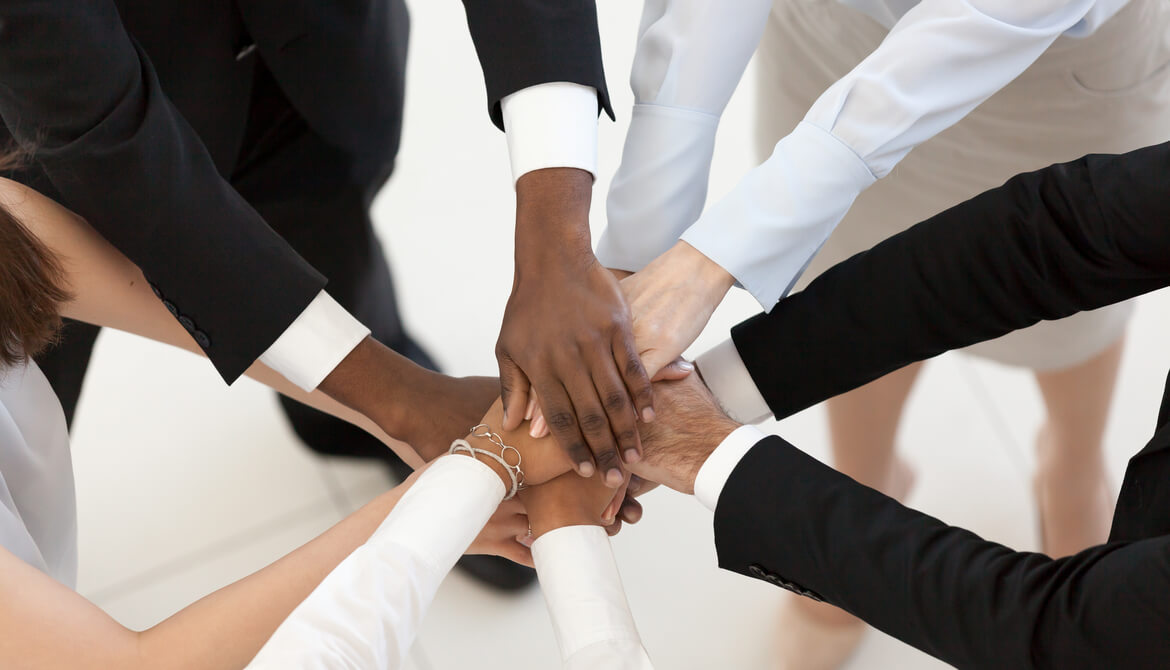 diverse business people put hands together