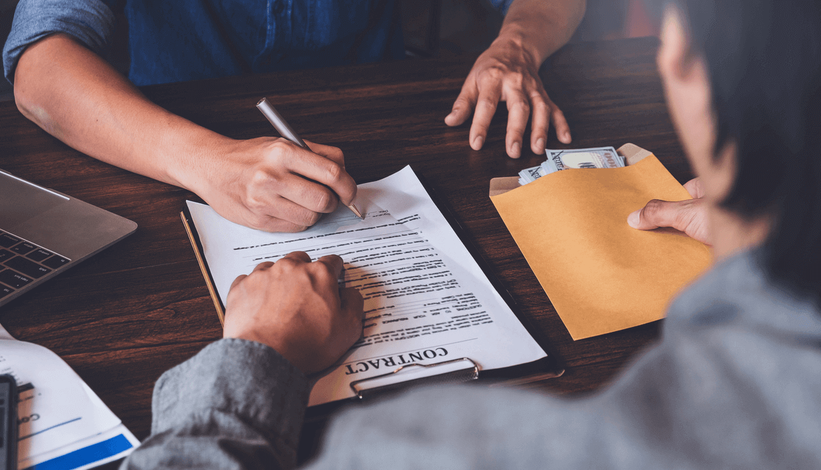 Man signs a loan agreement with a loan officer