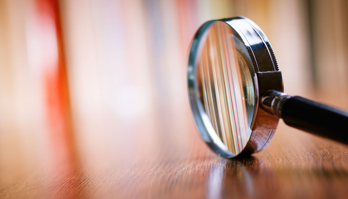 magnifying glass on table with blurred background
