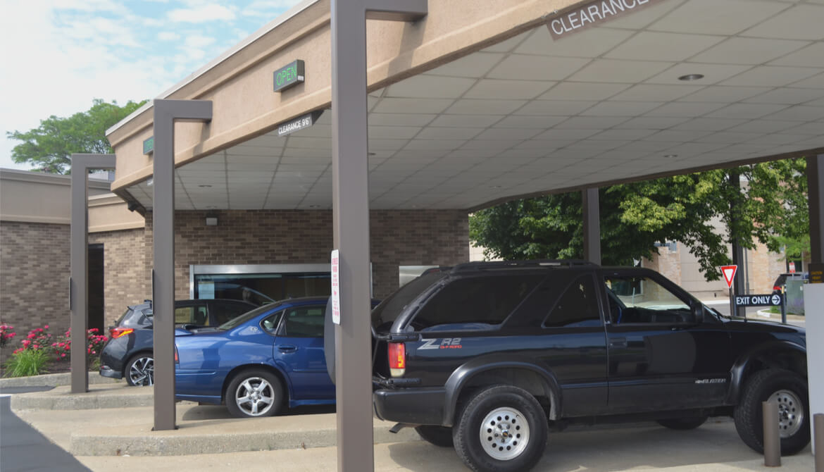 cars in busy credit union drive-thru lanes